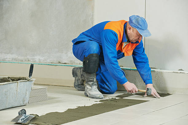istock tilers at industrial floor tiling renovation 493385890