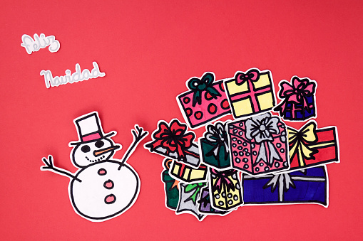 a Horizontal overhead view of a scrapbook xmas greeting with a Happy xmas message in Spanish