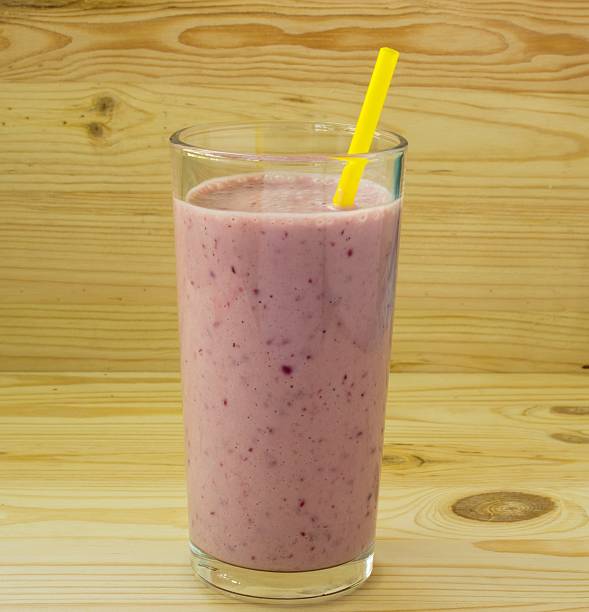 istock Smoothie with strawberry and yellow straw 493386636