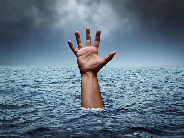 istock Drowning hand in stormy sea 493433954