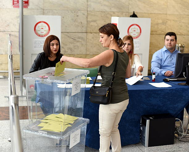 Woman voting for Turkish general elections Ankara, Turkey - October 19, 2015: A Turkish citizen woman is voting at voting desk for Turkish general elections at Ankara Esenboğa Airport. turkish culture stock pictures, royalty-free photos & images