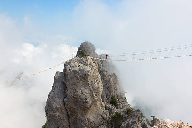 Rope bridge over the chasm Rope bridge over the precipice on Mount Ai-Petri bridge crossing cloud built structure stock pictures, royalty-free photos & images