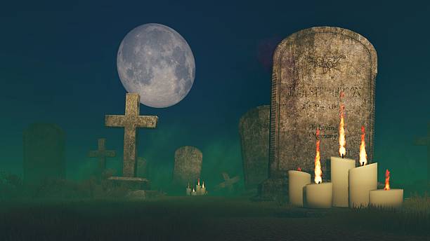 istock Lighted candles near the old tombstone 493436976