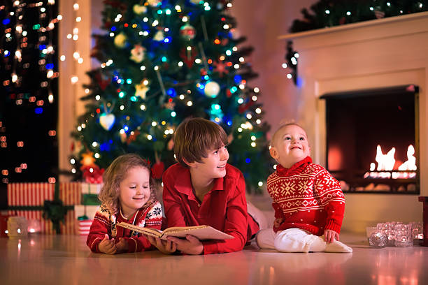 istock Kids playing at fireplace on Christmas eve 493437548