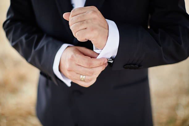 istock Man in tuxedo adjusting his cufflinks 493438042