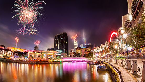 Fireworks set off in the backdrop to the Singapore River along Clarke Quay as a precursor to Singapore's 50 years of independence celebration. The area used to be a commercial center during the colonial era where warehouses are located. Now, it is converted into a popular meeting place for locals and tourists alike.