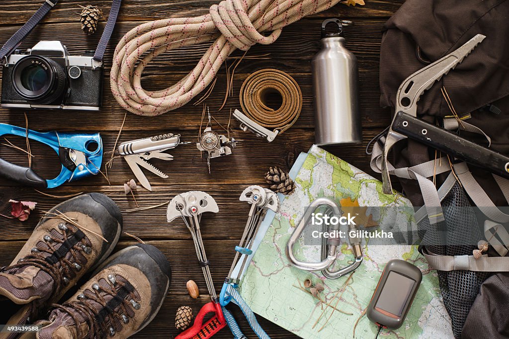 Equipment necessary for mountaineering and hiking Equipment necessary for mountaineering and hiking on wooden background Equipment Stock Photo