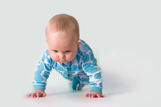 Baby doing push-ups stock photo