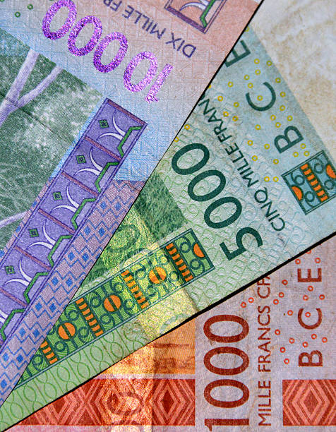 West African CFA franc bank notes West African CFA franc bank notes, 1000, 5000, 1000 francs. Currency of Benin, Burkina Faso, Guinea-Bissau, Ivory Coast, Mali, Niger, Sénégal and Togo -issued by the BCEAO, Banque Centrale des États de l'Afrique de l'Ouest / Central Bank of the West African States. UEMOA, Union Économique et Monétaire Ouest Africaine / West African Economic and Monetary Union - the CFA Franc is pegged to the Euro.  XOF currency code. french currency stock pictures, royalty-free photos & images