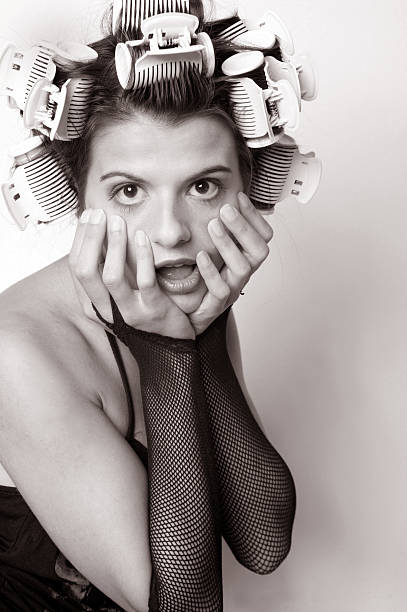 istock Young woman with curlers 493443965