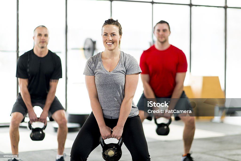 Kettlebell Swing Group of people doing kettlebell excercises. 20-29 Years Stock Photo