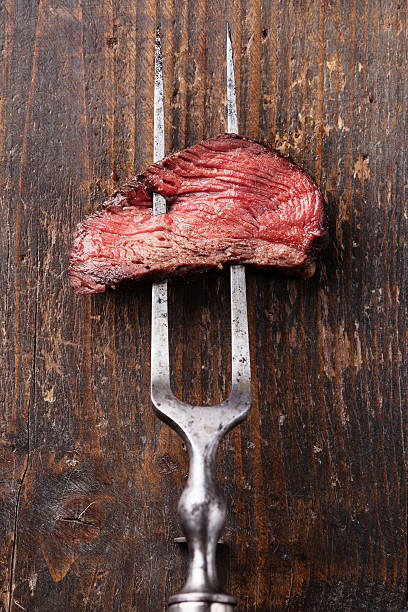 istock Piece of beef steak on meat fork 493445013