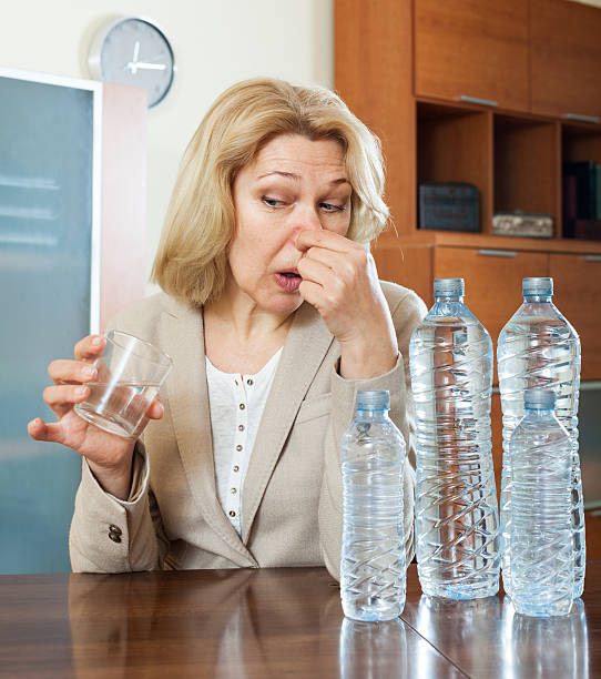 istock woman with  poor quality water 493445147