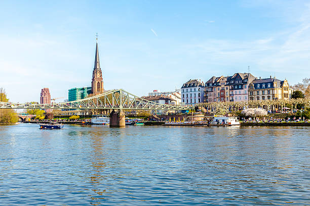 people at Eiserner steg  in Frankfurt, Germany. The Eiserner Steg is a pedestrian bridge in Frankfurt am Main built in 1868.