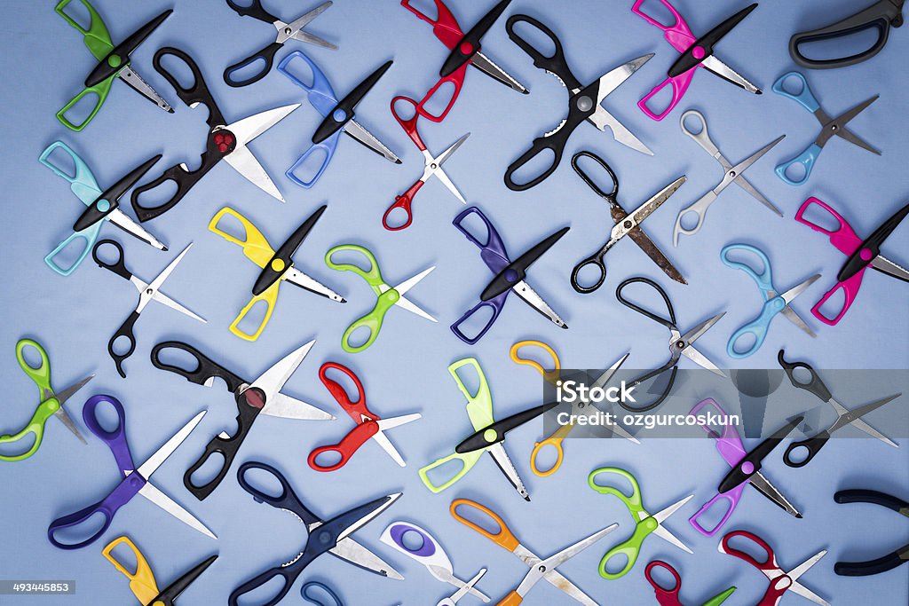 Background of scissors with open blades Background of scissors with open blades srranged neatly in a blue background with all their handles facing in the same direction, view from above Arrangement Stock Photo