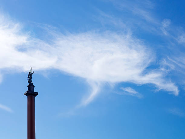 Cloudy sky background with angel statue on top the Alexander Column in palace square, St.Petersburg, Russia