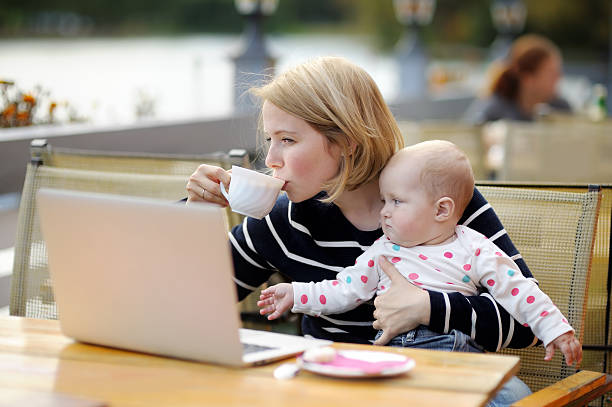 istock Young mother with her baby working or studying on laptop 493446186