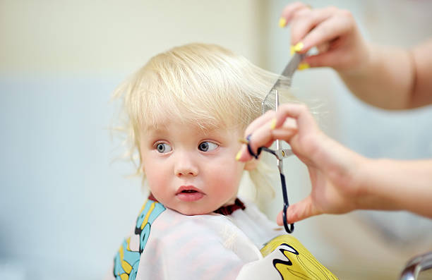 istock Toddler child getting his first haircut 493446660