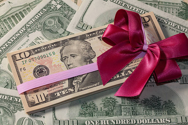 istock Pack of dollar bills with red bow 493447679