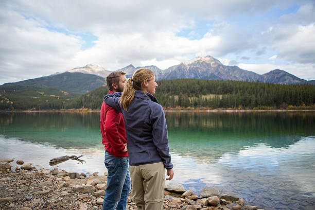istock Young couple by the lake looking at view 493447780