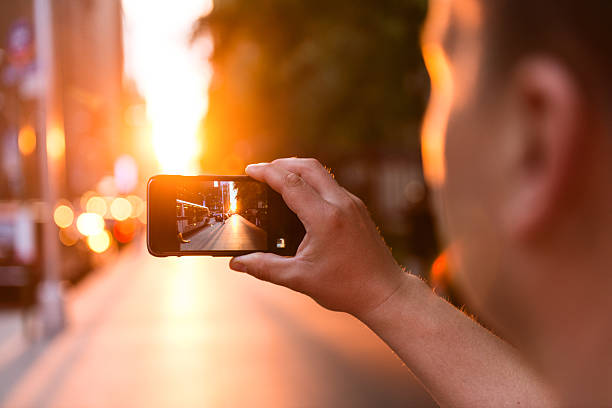 Capturing moments Shot of a man taking a photo with a phone camera. cityscape videos stock pictures, royalty-free photos & images
