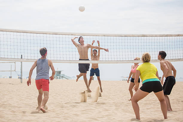 istock Volleyball player spiking ball against opposing team 493448360