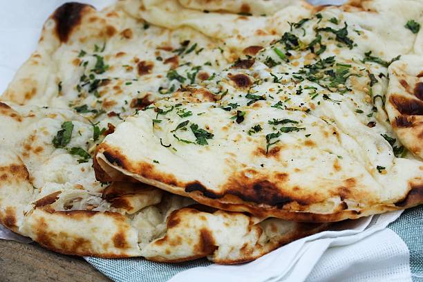 istock Garlic Naan  Indian Flat tandoor bread close up 493448466