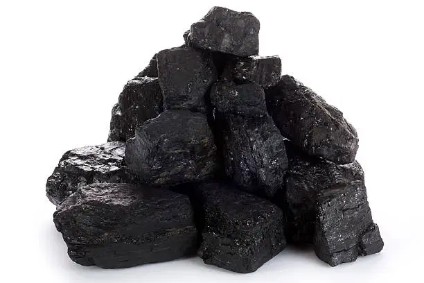 Stack of coal lumps on white background