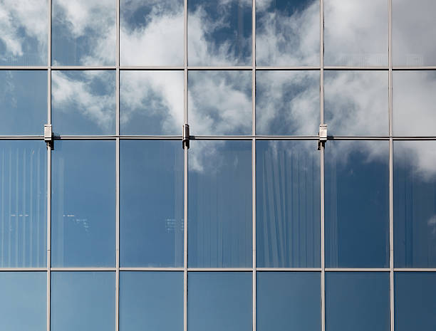 istock Blue sky with fluffy clouds reflected in the glass. 493449779