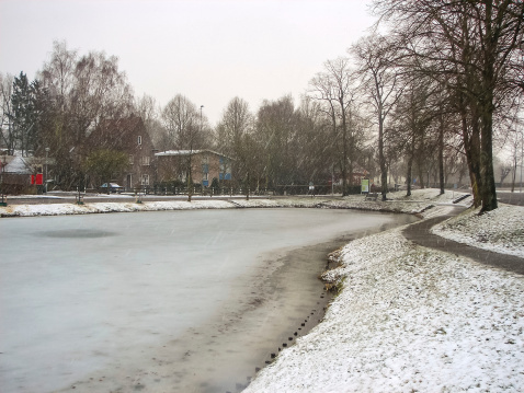 Snowfall on winter lake in the Dutch city Heerlen. Netherlands