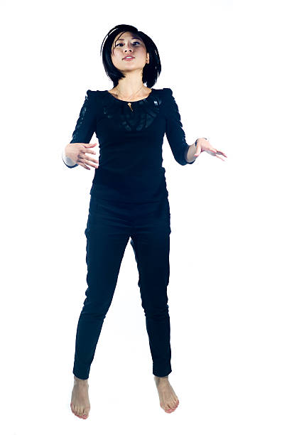 A young Asian woman posing against a white background