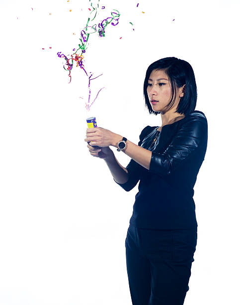 istock Asian girl with a party popper 493451043