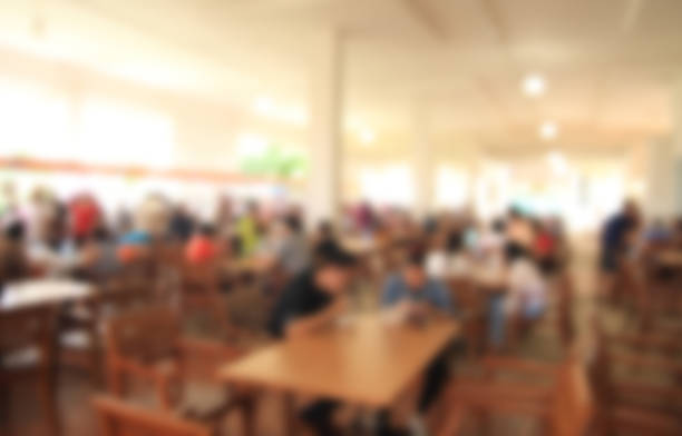 istock blurred image people in food center with light bokeh. 493470688
