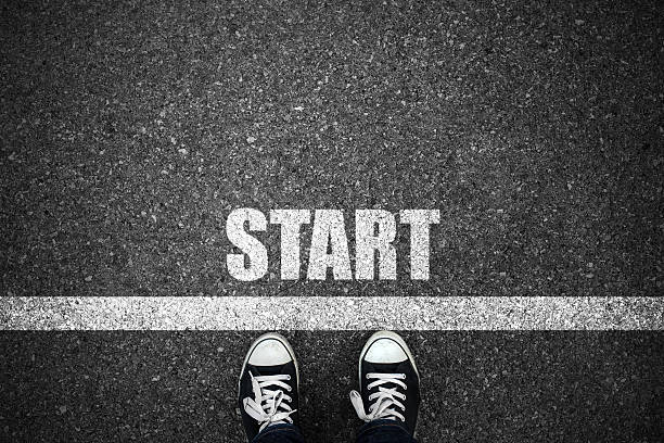 istock People at a starting line with start text on floor 493471862