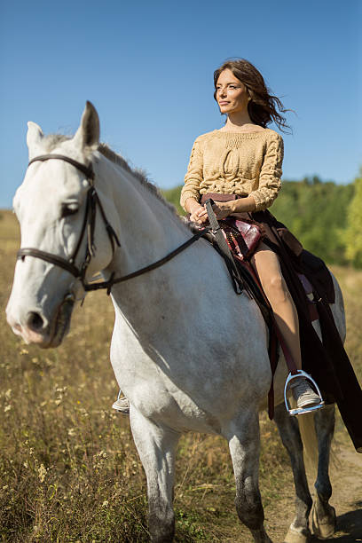 istock Beautiful girl riding a white horse 493472706
