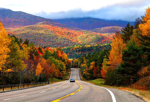 Scenic road in the Adirondacks region of New York during the autumn foliage season