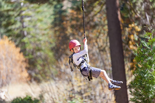 kid ziplining stock photo