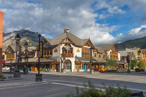 Tourists and visitors on the street enjoying the hotels, restaurants and retail facilities of the town of Banff in Banff National Park in Canada.