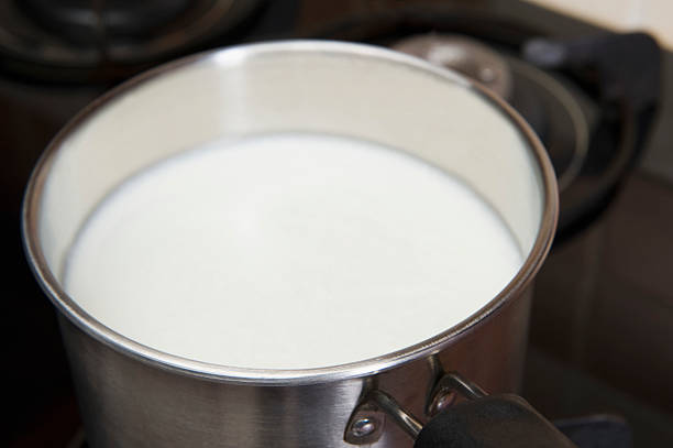 istock Milk in a saucepan on a gas stove burner 493477926