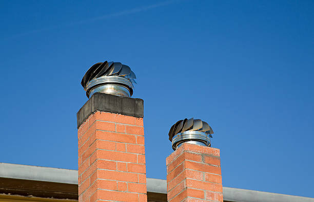 Chimney Caps Two Chimney Caps with blue sky as background smoke stack stock pictures, royalty-free photos & images