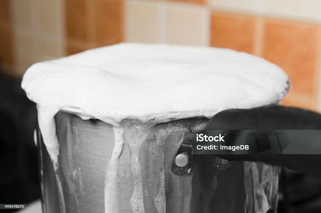 Milk boiling over a pan Milk Stock Photo