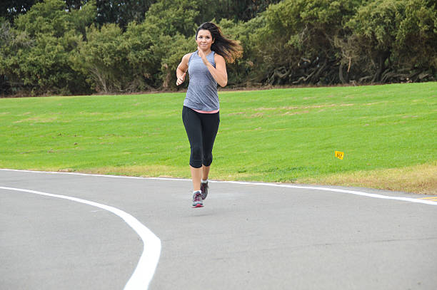 istock Athletic young woman running on track 493479122