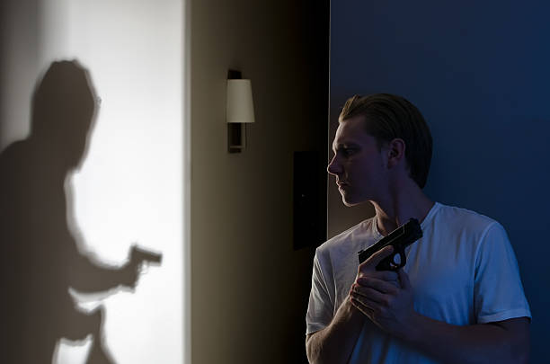 Armed Robber Breaking In Armed resident ready to protect themselves against robber self defense stock pictures, royalty-free photos & images