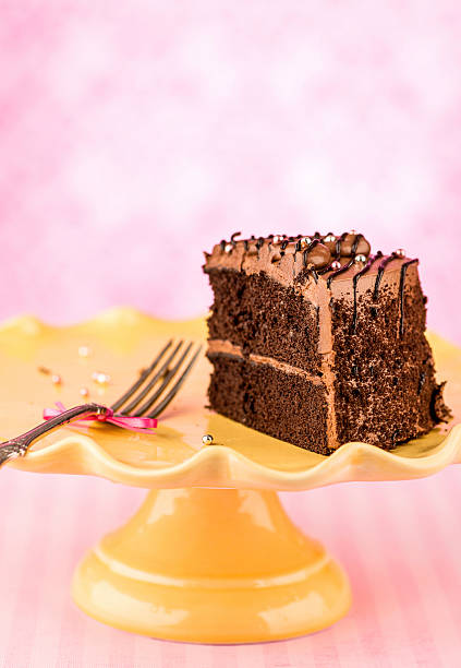 istock Slice of chocolate cake on a cake stand with fork 493479256