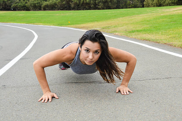 istock Athletic skinny woman doing push ups on track 493479356