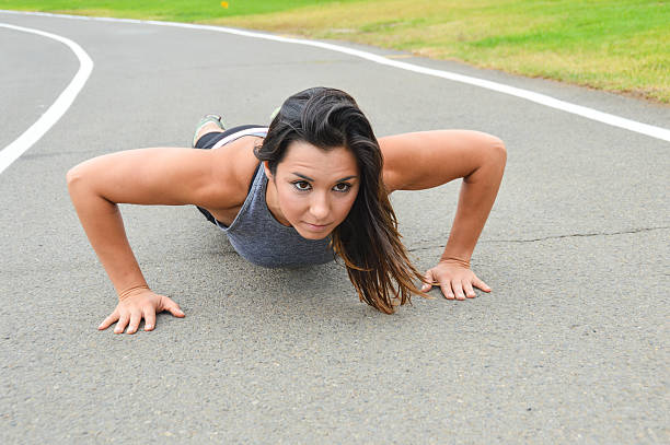 istock Athletic skinny woman doing push ups on track 493479466