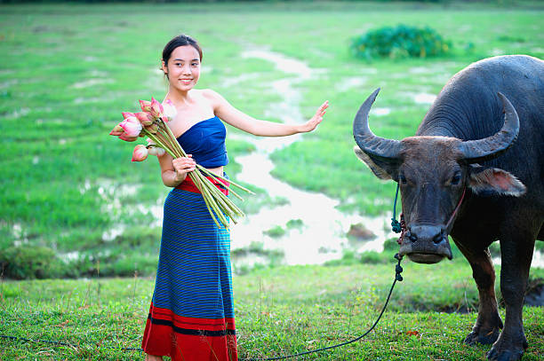 istock thai ancient young women with buffalo on rural 493480680