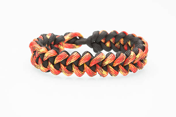 istock black and orange braided bracelet on white background 493481938