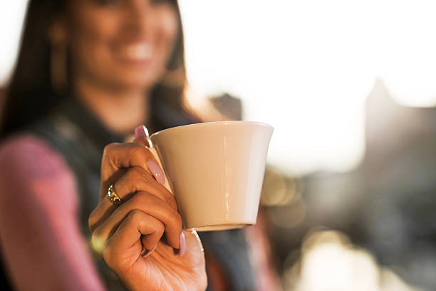 istock Close up of a white coffee cup in woman's hand. 493483360