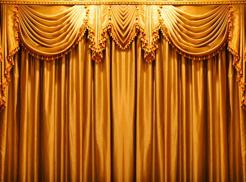 close up the detail of gold fabric curtain on the state of theater.interior background